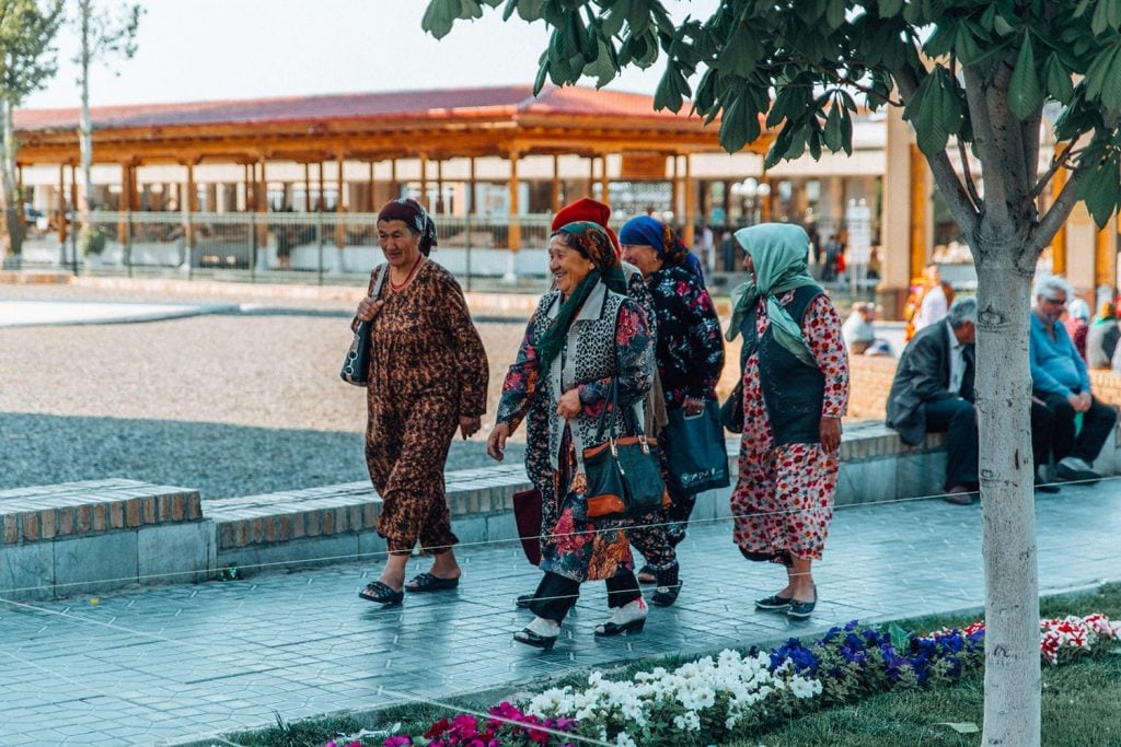 local ladies in colorful clothing walking on the street of uzbekistan