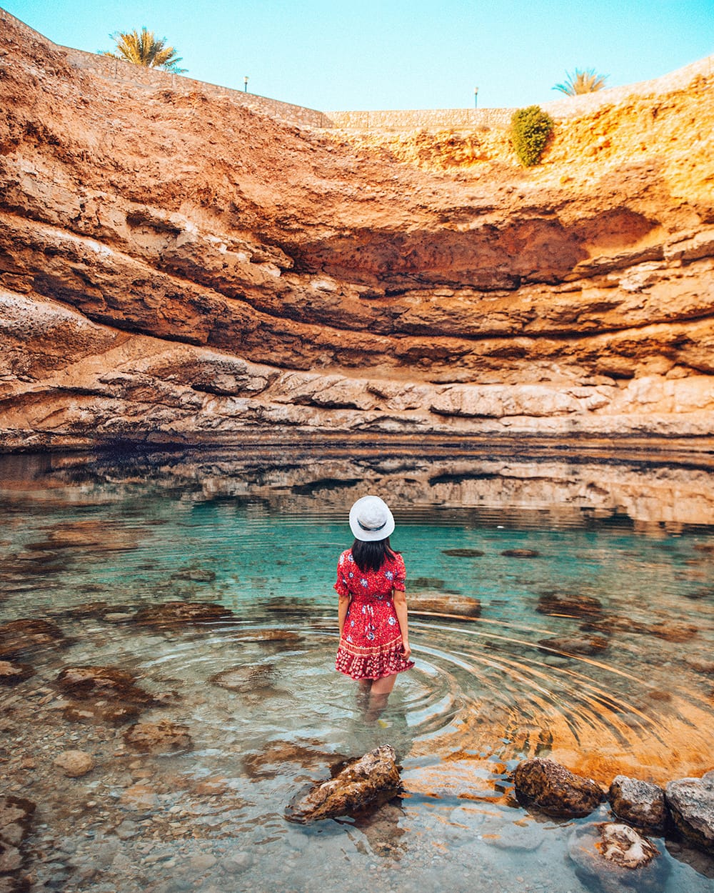 girl standing inside bimmah sinkhole
