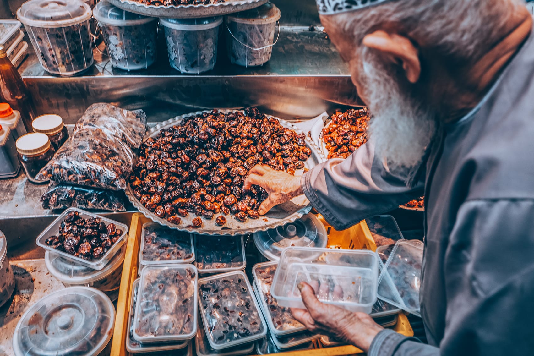 man picking up dates at a market