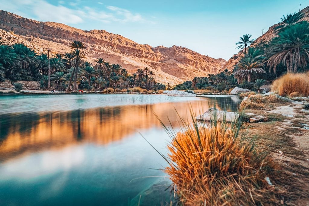 the view of a pool and mountains in wadi bani khalid
