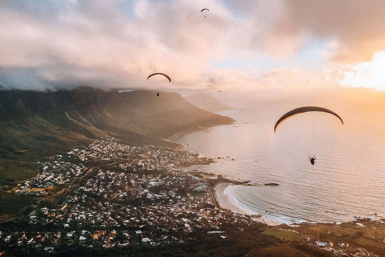 a parachute flying above the coastline of cape town south africa