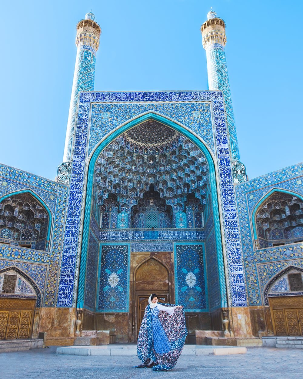 girl standing in front of shah mosque in esfahan iran