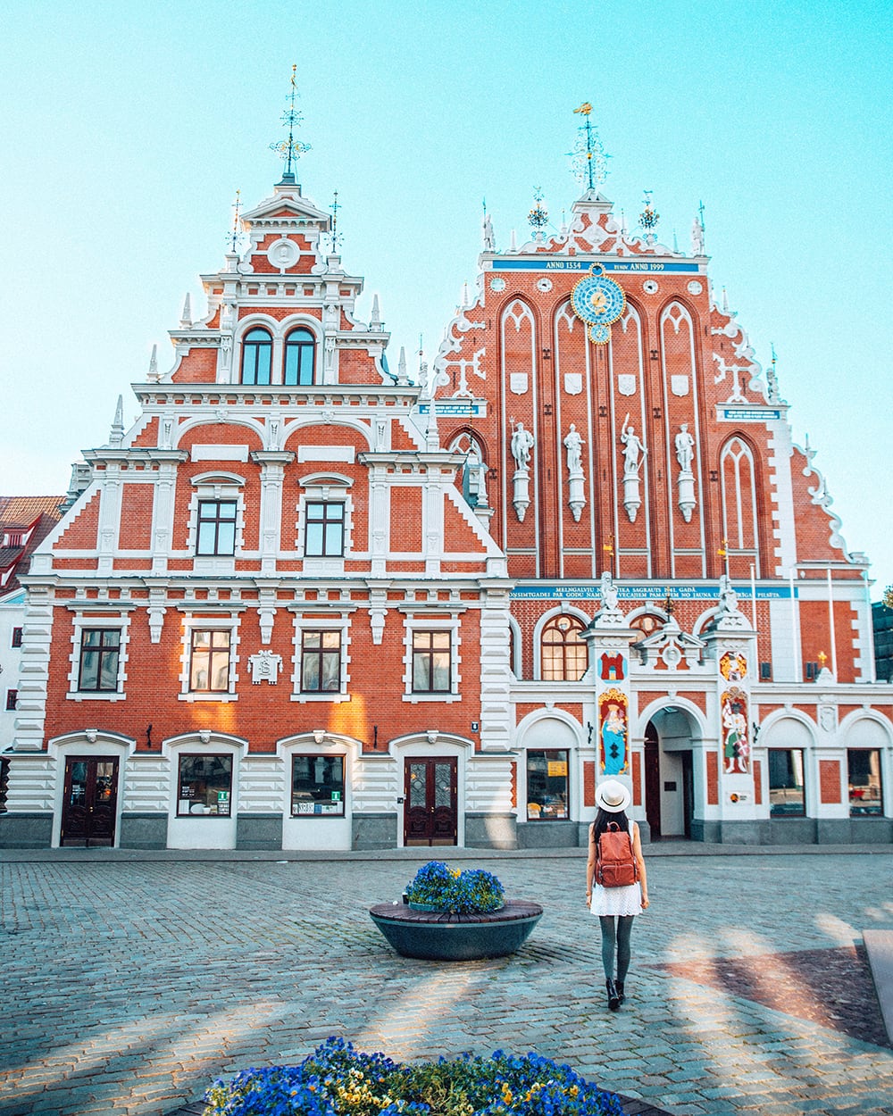 red buildings in a square in riga latvia