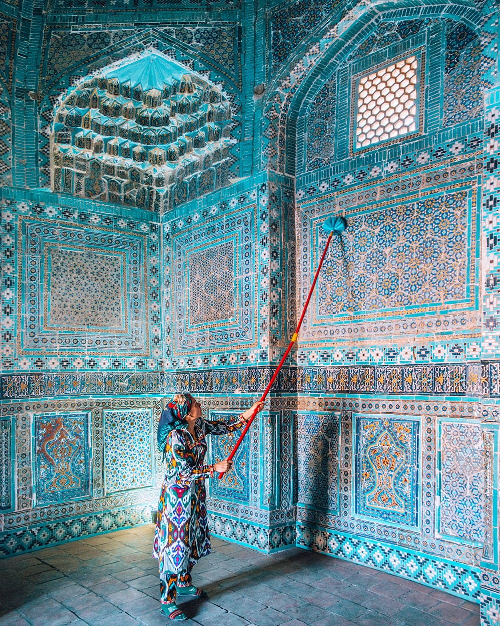 woman standing in shah i zinda mausoleums in samarkand uzbekistan