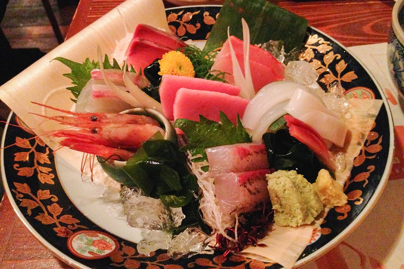 a plate of sashimi in a restaurant in tokyo japan