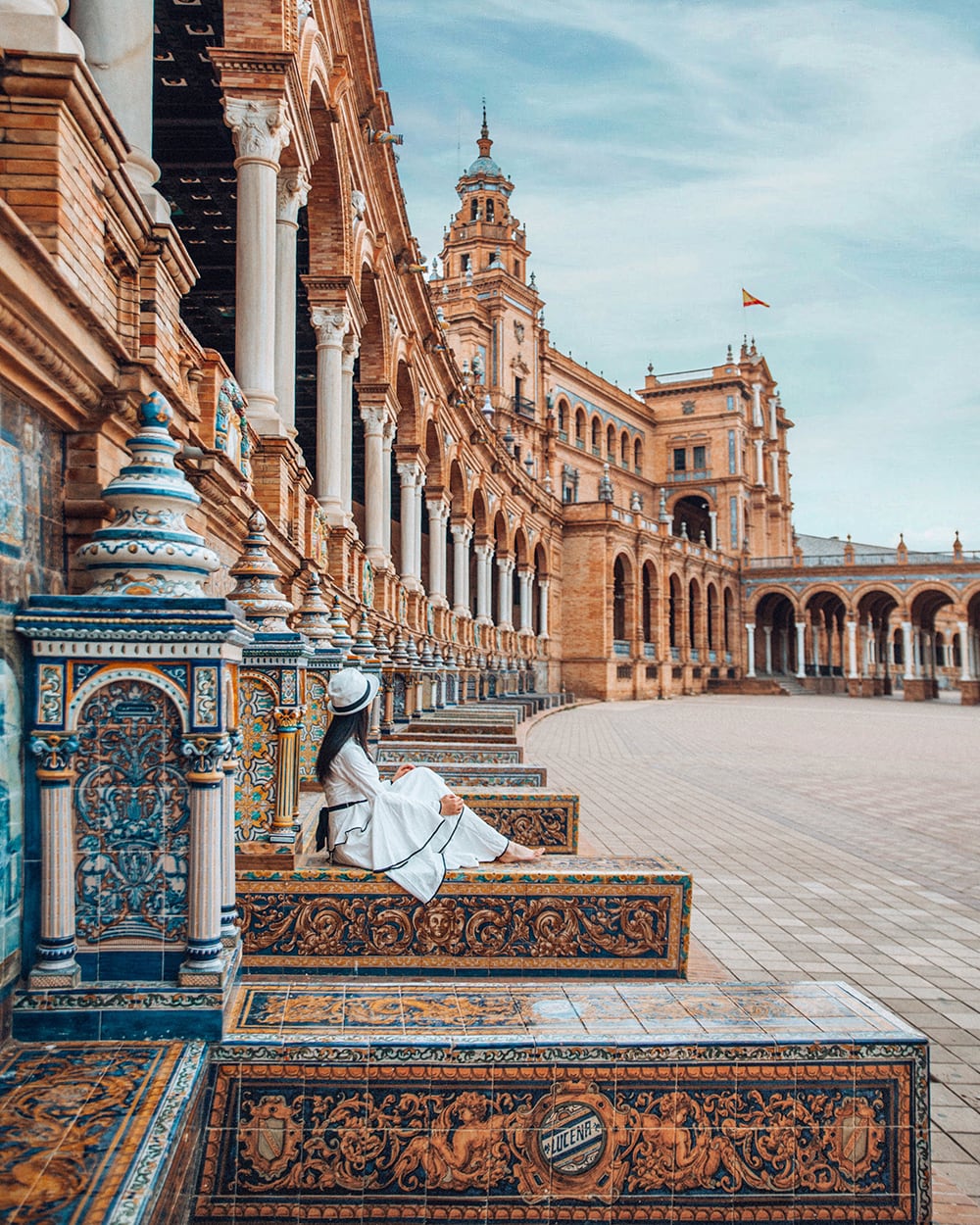 girl sitting in plaza de espana in seville spain