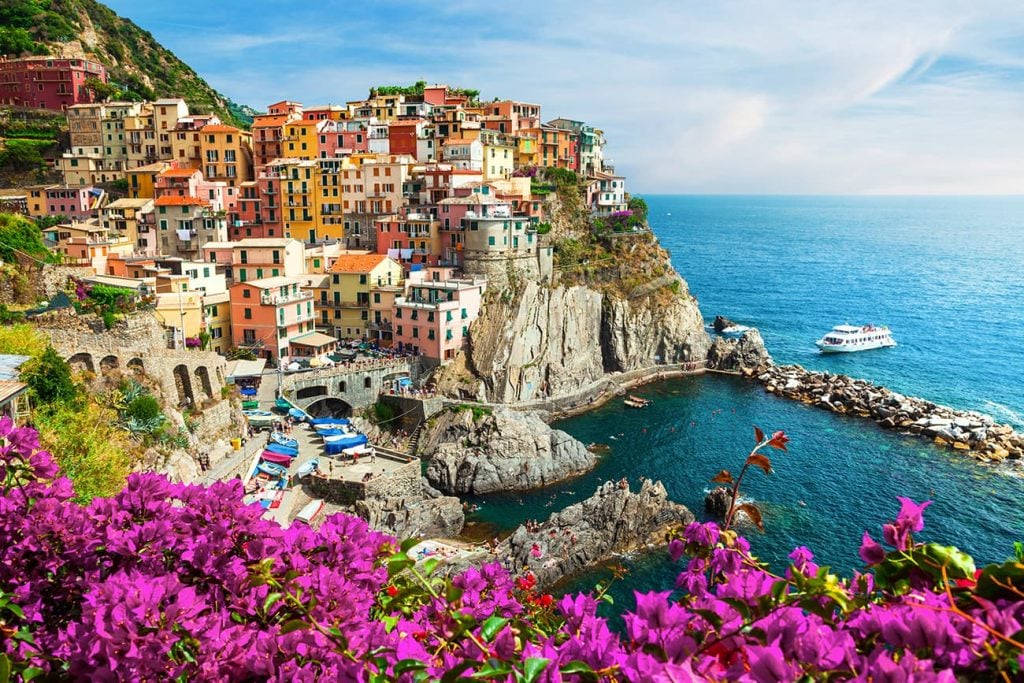 Flowers, Houses, and the Coastal View of Manarola, a Village in Cinque Terre, Italy