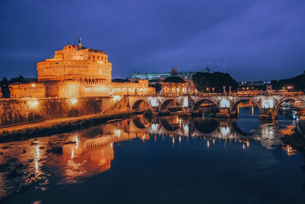 Castel Sant'Angelo Reflecting in River Tiber at Night in Rome, Italy