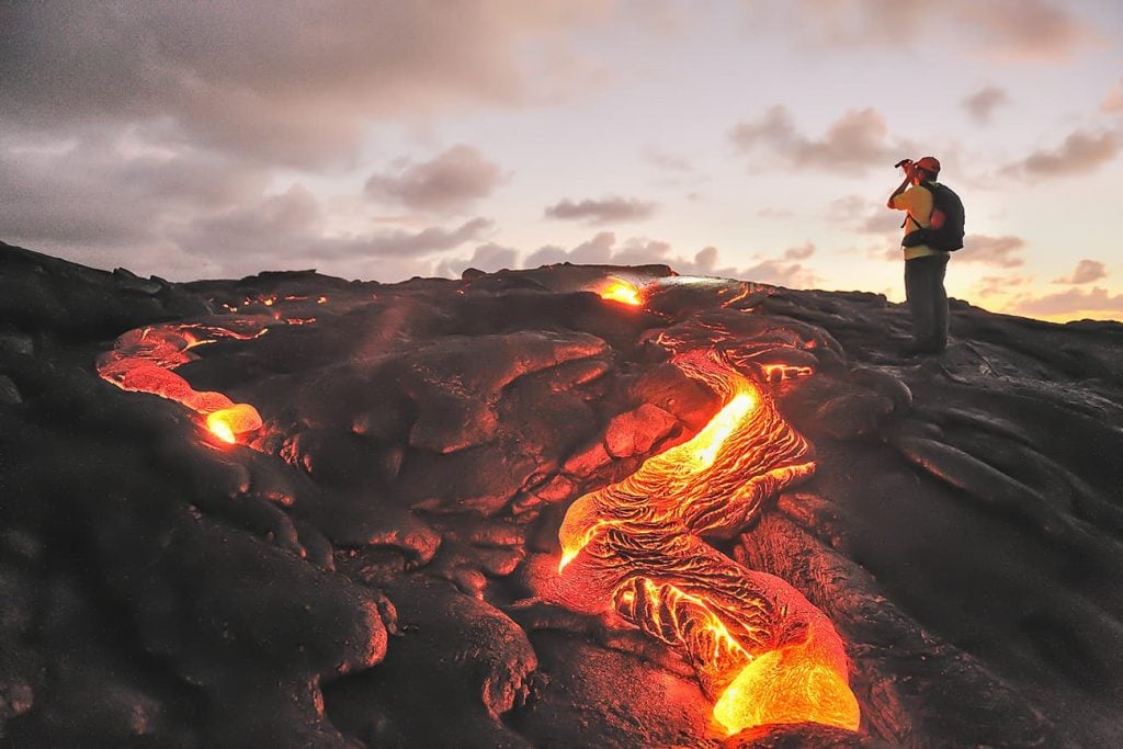 A Photographer Standing By Lava in Hawaii Volcanoes National Park