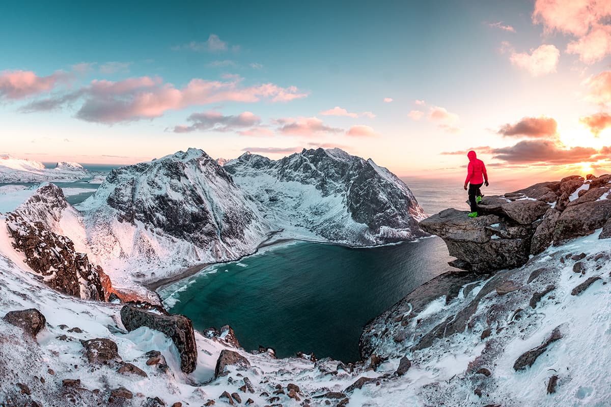 A Man Standing In Front of Snowcapped Mountains