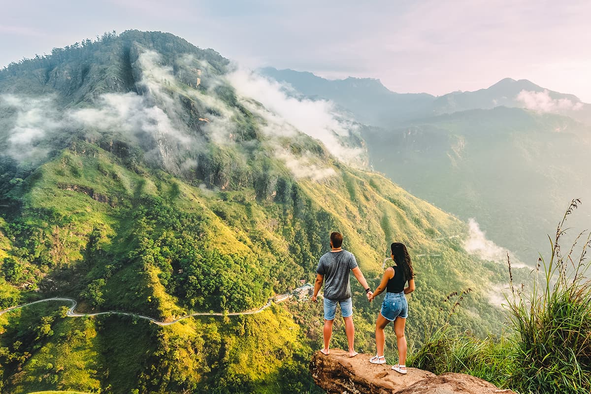 Couple Standing In Front of a Mountain