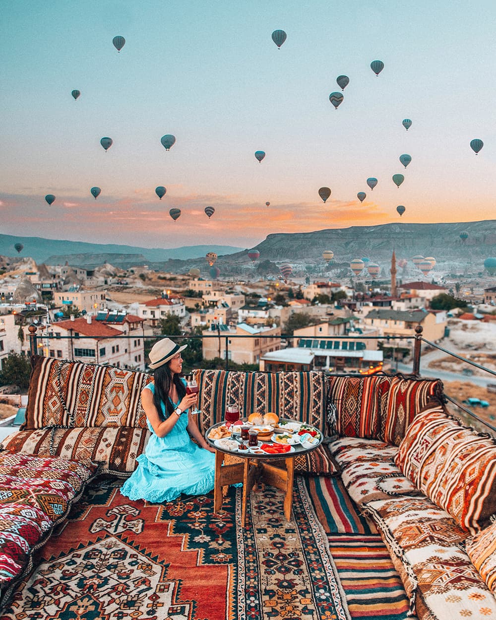 A Girl Enjoying the View of the Sun Setting Over Cappadocia, Turkey