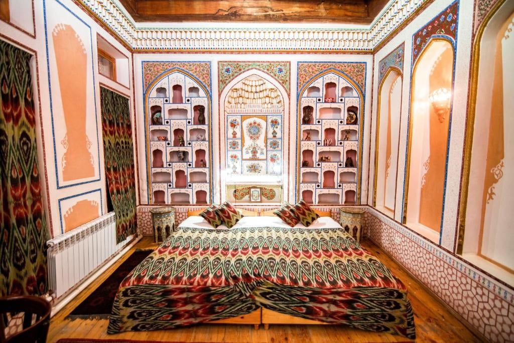 a room with a bed and shelves