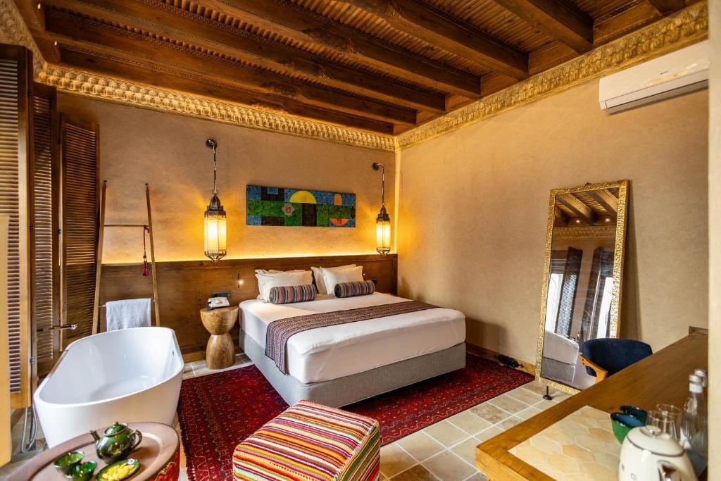 a bedroom with a bathtub and a bed