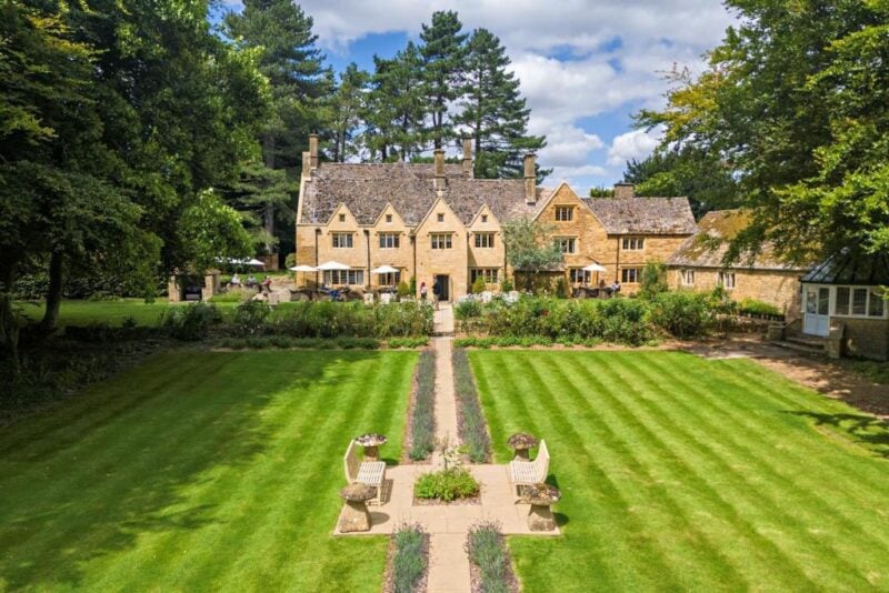 a large lawn with a stone building and a garden